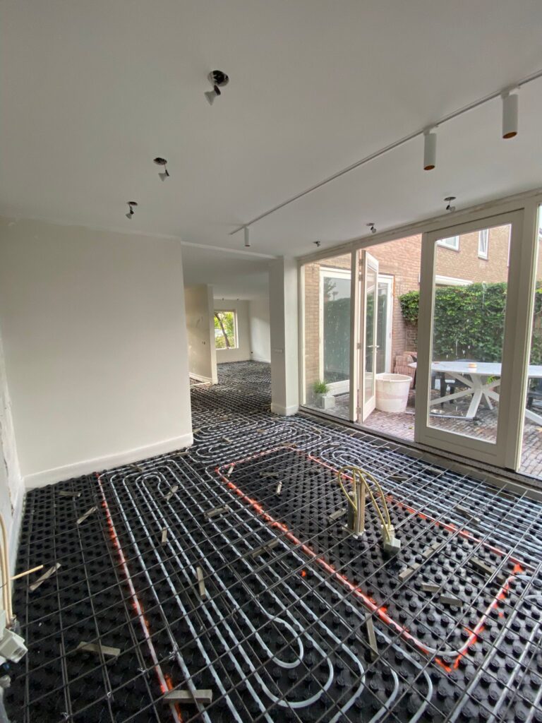 Voorbereidingswerk voor het storten van woonbeton. Het leggen van wapening bovenop de basisvloer met schuimbeton en vloerverwarming.